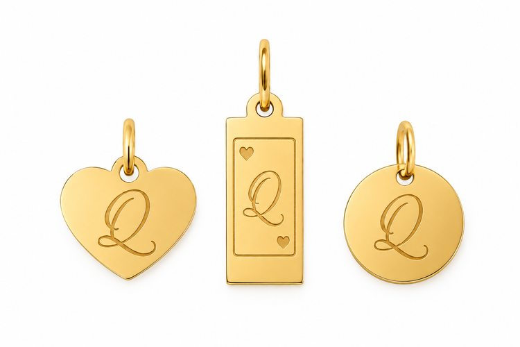 Three gold Queenie tags engraved with a script Q: a heart, a rectangle, and a round disc